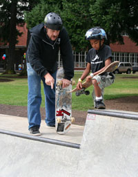 instructor showing skateboarder how to drop in